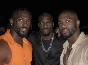 Black queer youth creating visual art during a community workshop.